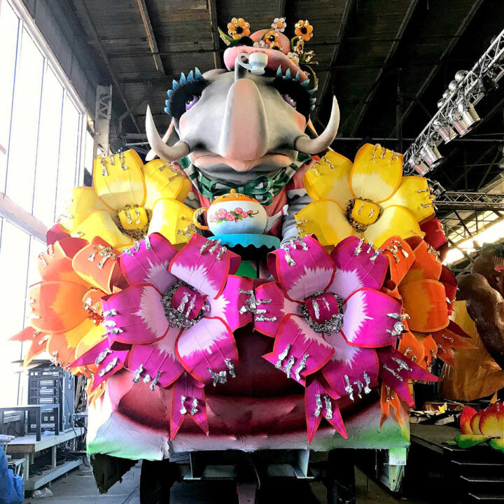 A flower covered float in the Mardi Gras World museum warehouse.