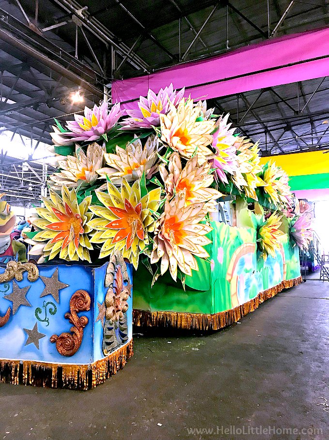 A colorful float decorated with large flowers.