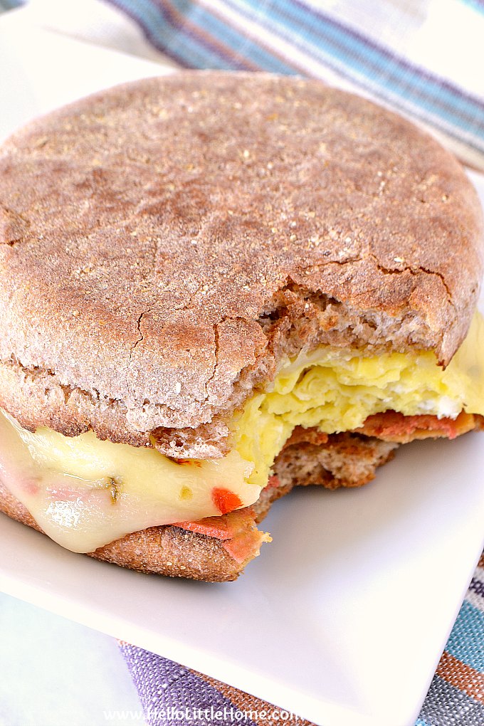A cheese and egg breakfast sandwich on a plate.