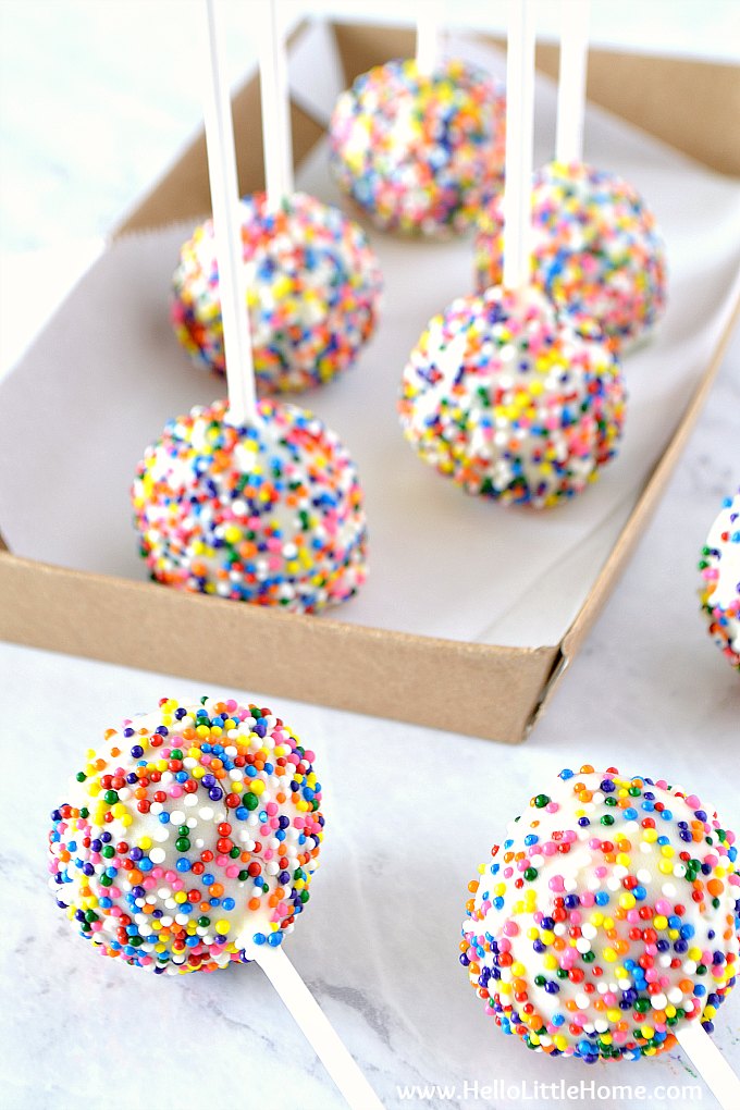 Birthday Cake Pops in a tray and on a table.