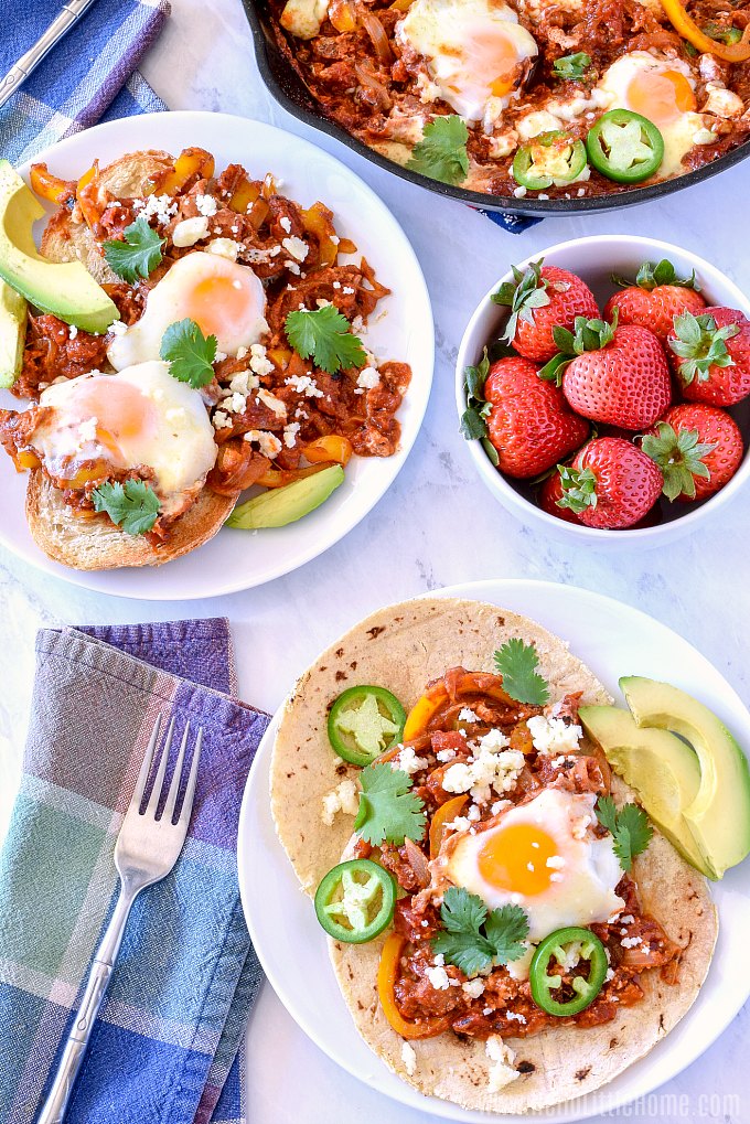 Two plates of Mexican Baked Eggs on a brunch table.