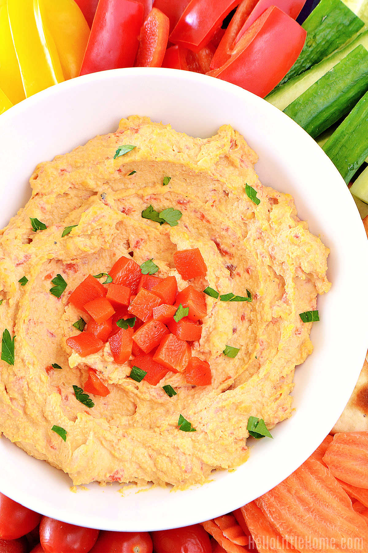 A bowl of the finished recipe surrounded by veggies.