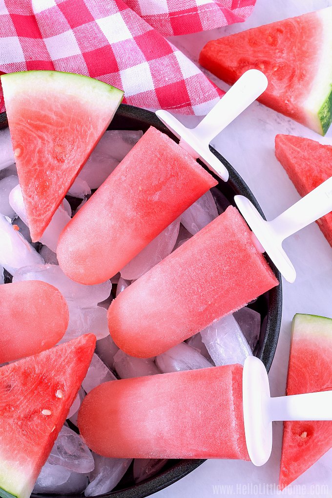 A tray of Popsicles and slices of fresh watermelon.