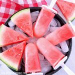 A tray filled Watermelon Popsicles and slices of melon.