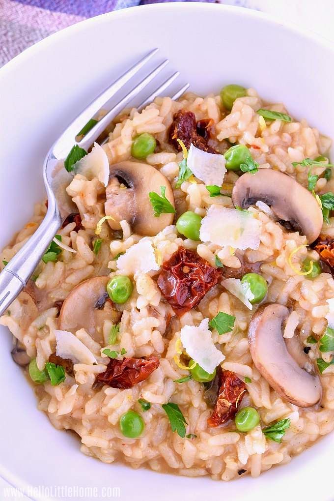 A bowl of Instant Pot Mushroom Risotto with a fork in it.