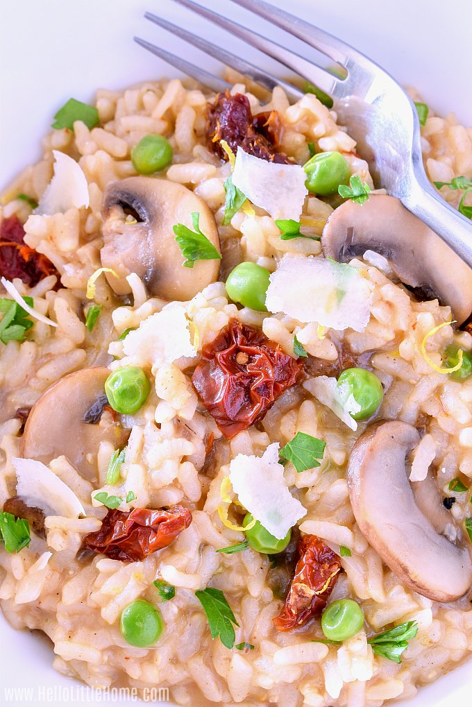 Closeup of Instant Pot Risotto with mushrooms, peas, sun dried tomatoes, and parmesan cheese.