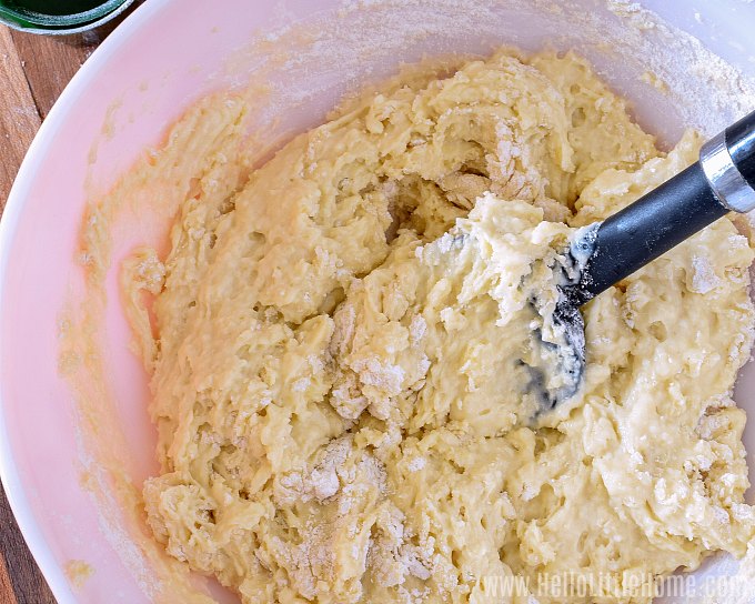 Mixing the wet and dry ingredients together with a spatula.