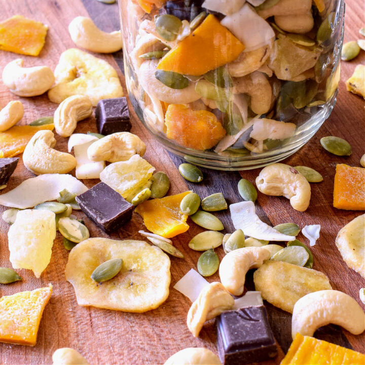Tropical Trail Mix scattered on a wood cutting board.