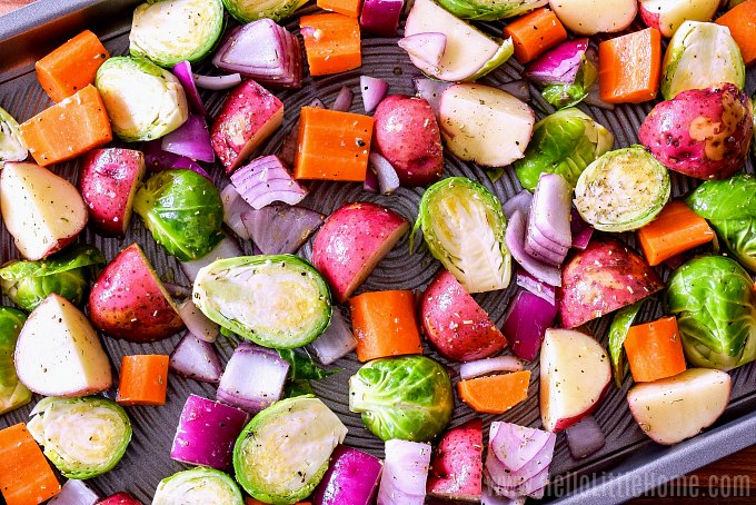 A sheet pan topped with raw veggies.