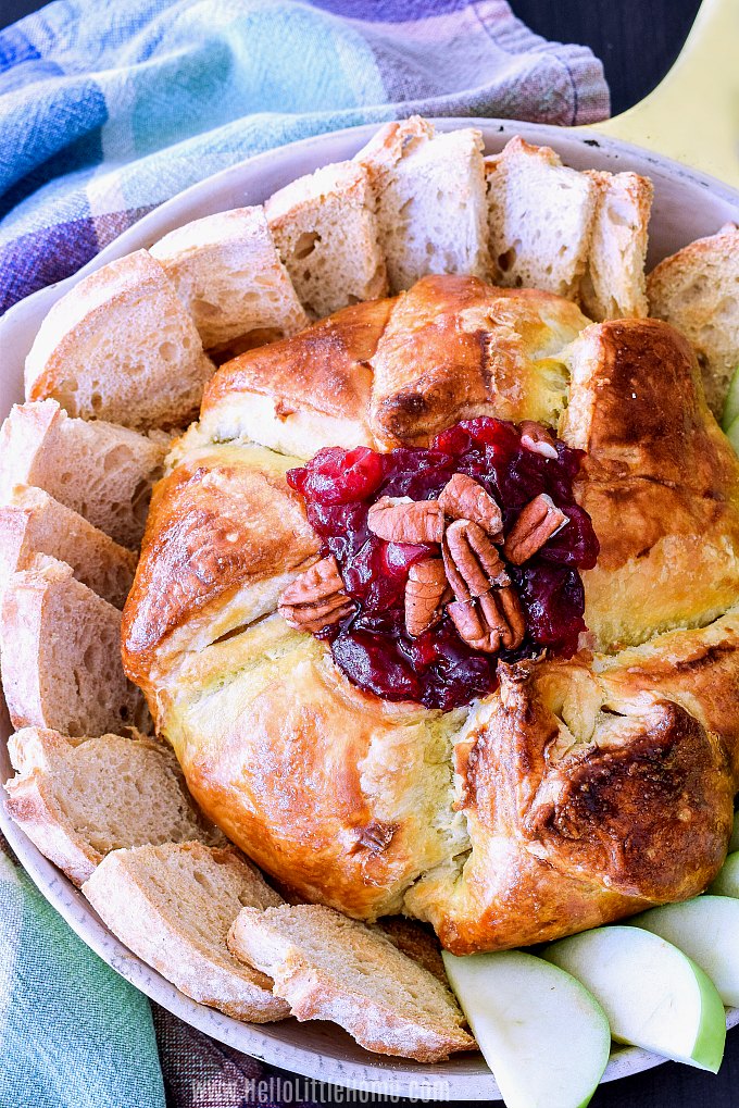 Baked Brie in Puff Pastry topped with cranberries and pecans.