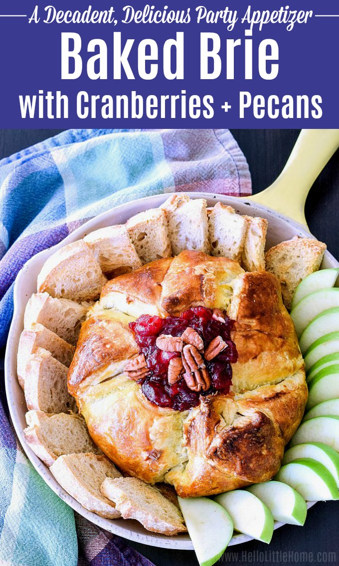 Baked Brie with Cranberries and Pecans served with crostini and fresh apple slices.