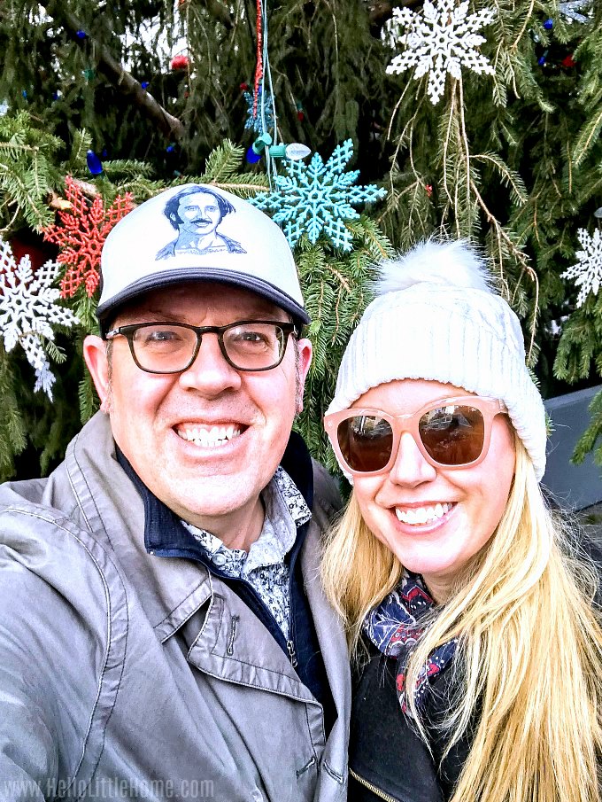 The author and her husband taking a selfie in front of an outdoor Christmas tree.
