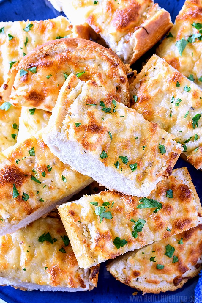 Closeup of a plate of sliced cheese garlic bread.