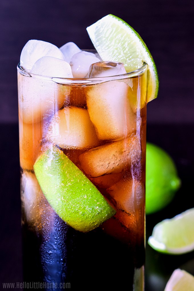 A Rum and Coke garnished with a lime wedge.