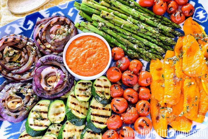 A platter of grilled vegetables served with romesco sauce.