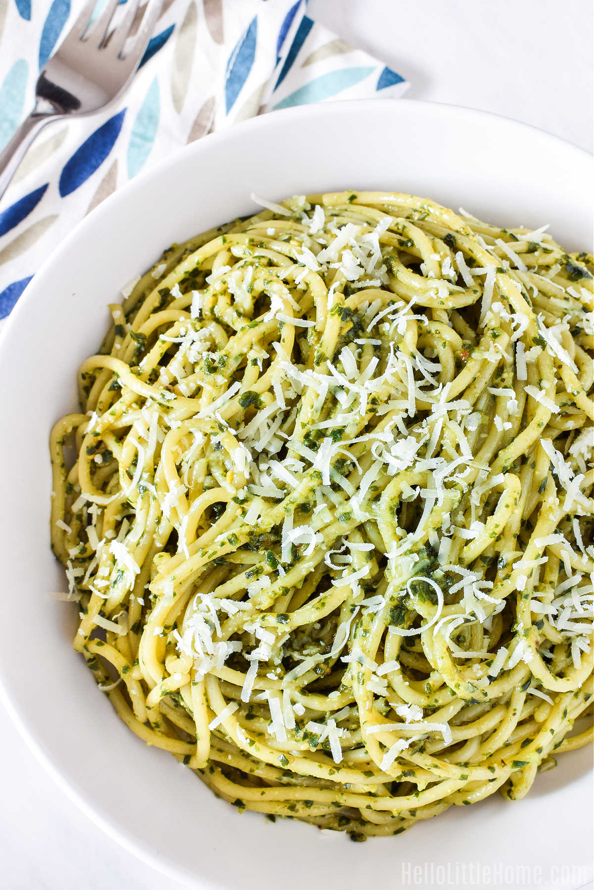 A bowl of the pasta served next to a napkin and fork.