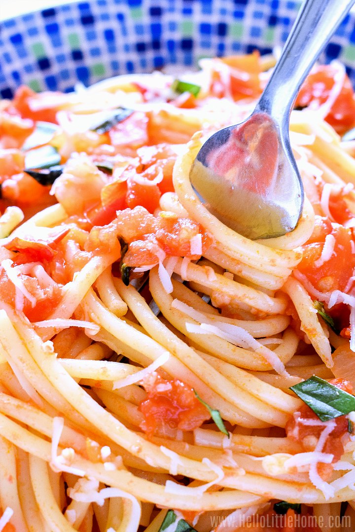 Closeup of a fork twirling spaghetti.