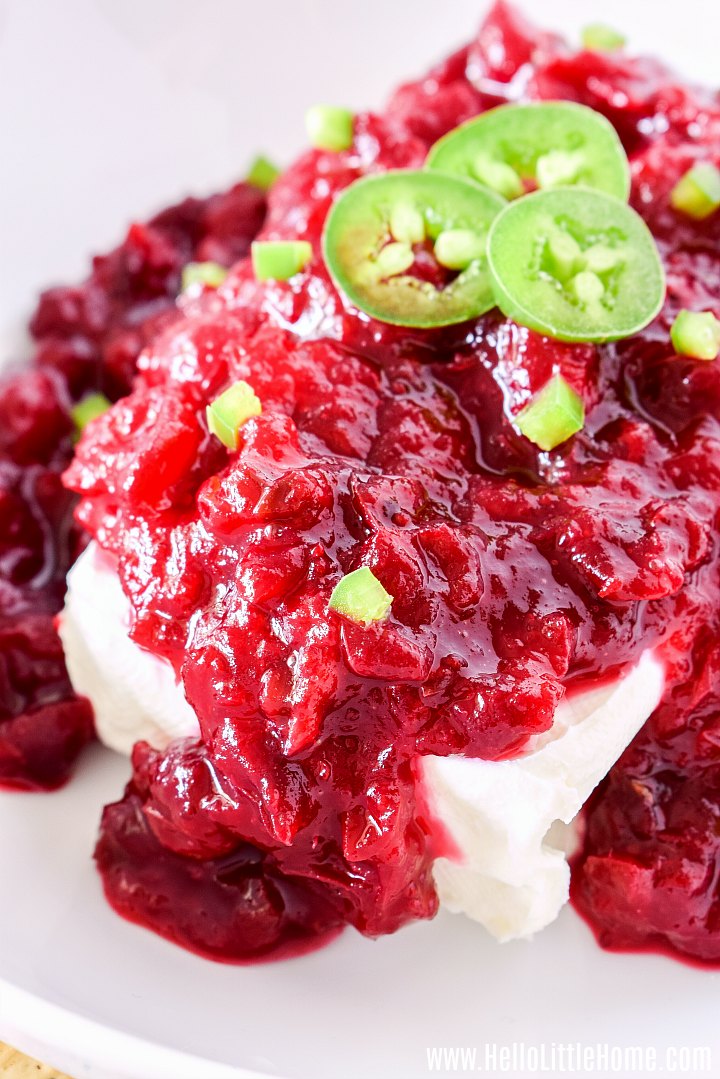 A Cranberry Jalapeno Cream Cheese Dip appetizer on a white platter.