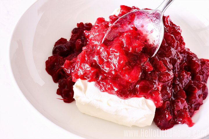 Topping cream cheese with cranberry sauce.