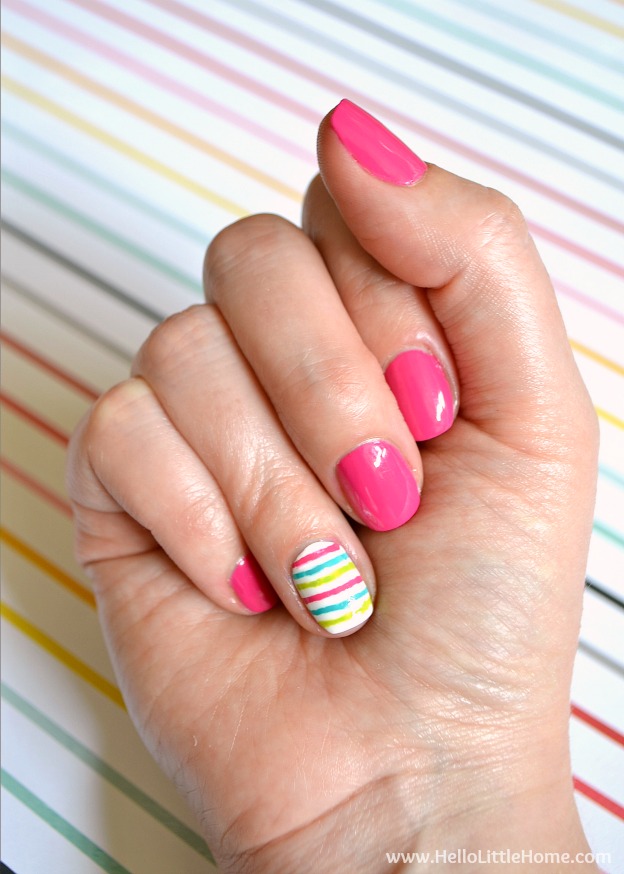 A hand with colorful nail polish.