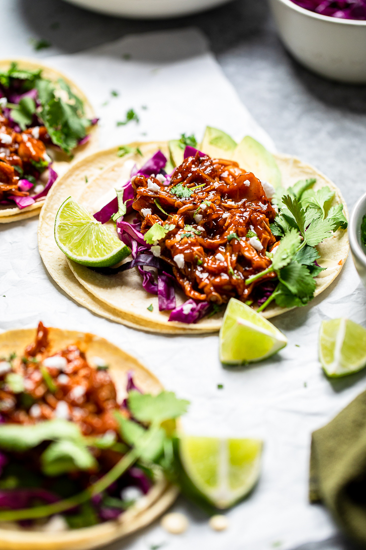 Jackfruit Tacos served with lime wedges.
