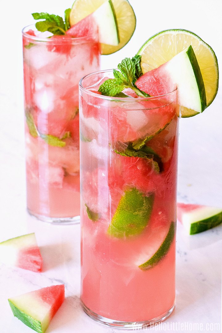 Two watermelon cocktails served in tall glasses on a marble counter.