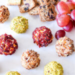 Savory Cheese Truffles, crackers, and grapes on a tray.