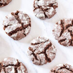 A counter topped with Chocolate Peppermint Crinkle Cookies.