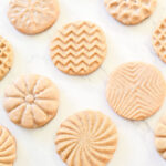 Stamped Cookies arranged on a marble counter.