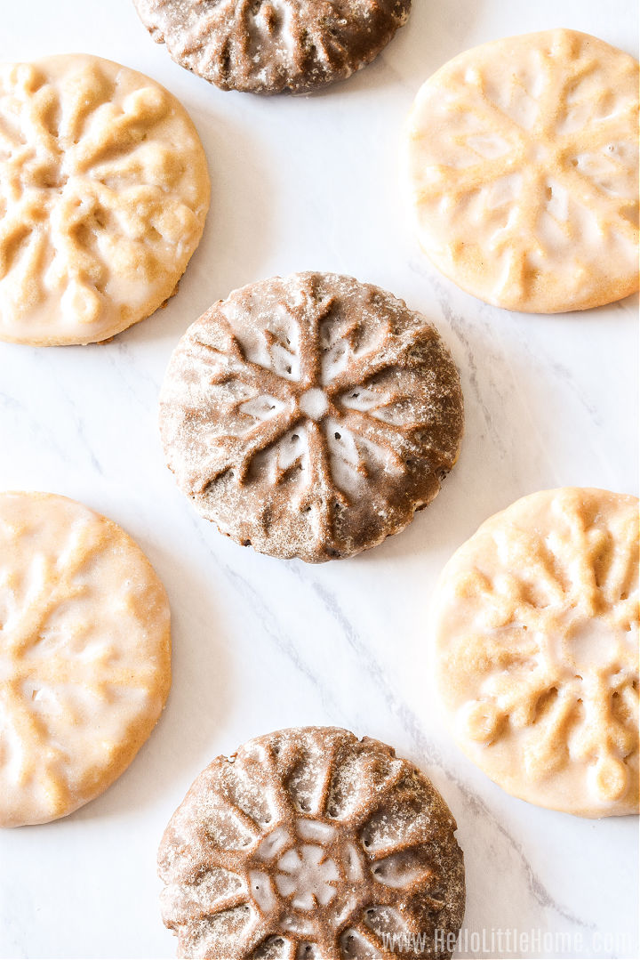 Cookies stamped with a snowflake stamp on a marble counter.