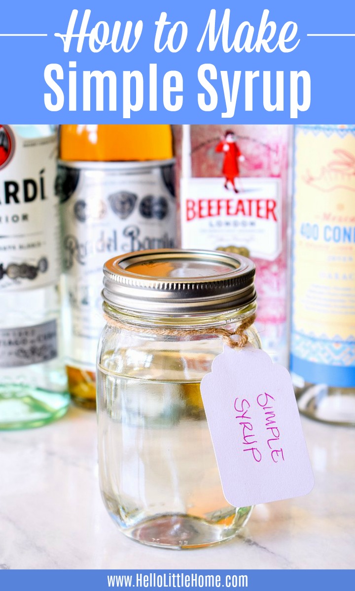 A jar of syrup with a white label tied around its neck with liquor bottles in the background.