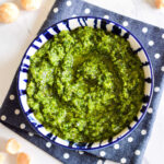 A blue patterned bowl filled with Macadamia Pesto.