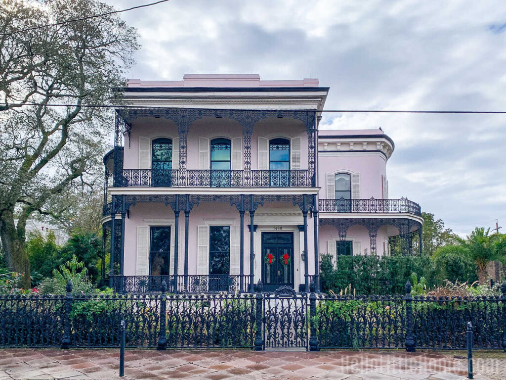 The exterior of Colonel Short's Village, a large pink mansion with a cast iron fence and railings.