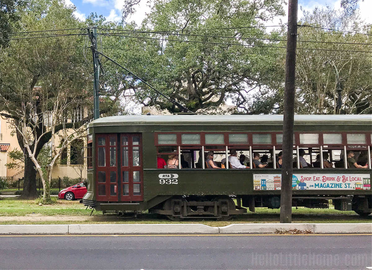 The St. Charles Streetcar moving past houses in the Garden District.