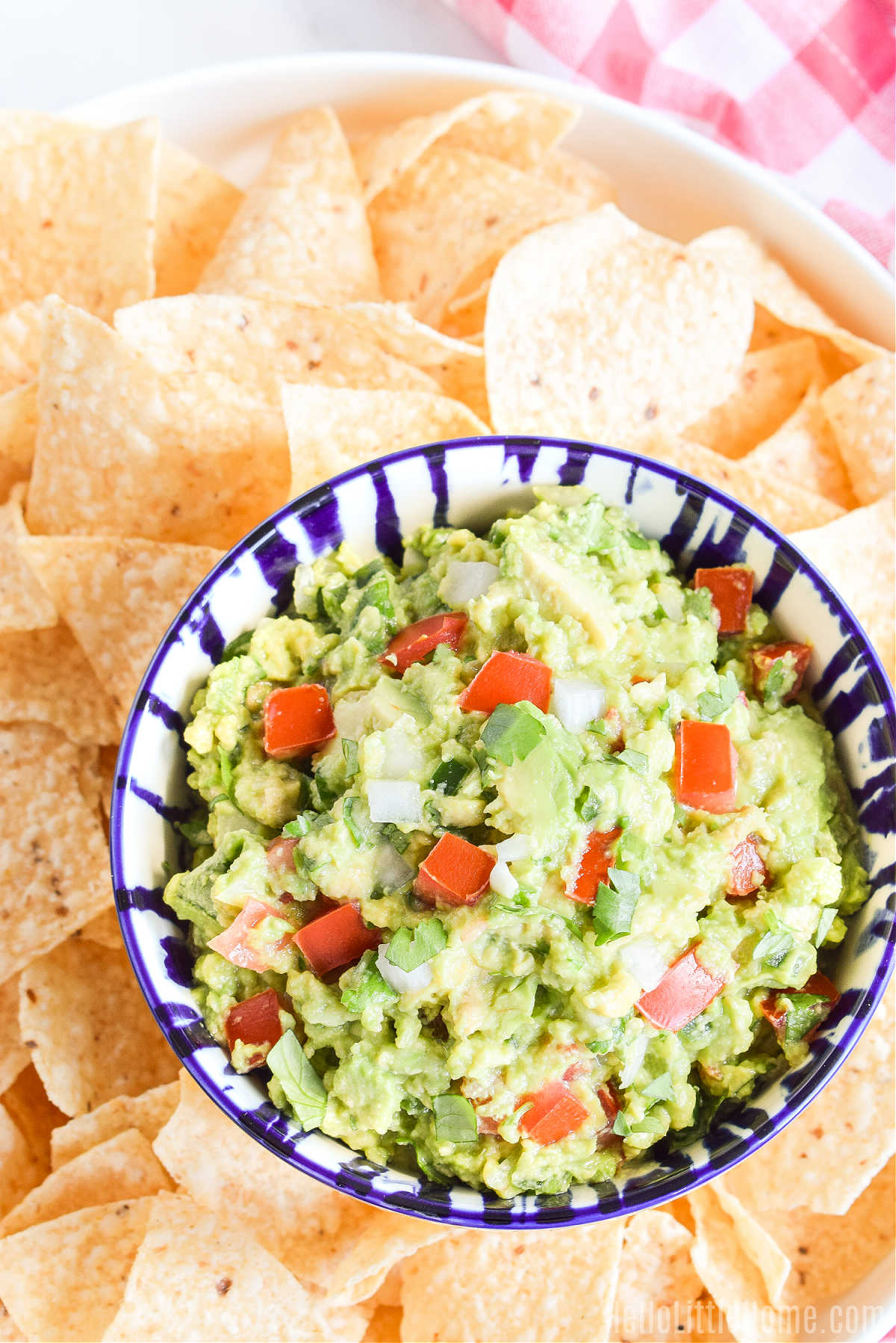 A bowl of the finished dip surrounded by tortilla chips.