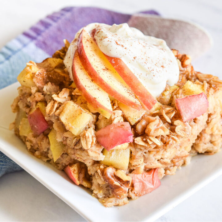 The Apple Baked Oatmeal recipe served on a plate next to a plaid napkin.