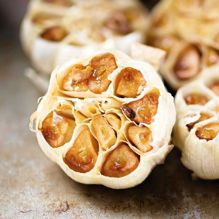 Closeup of a head of roasted garlic.