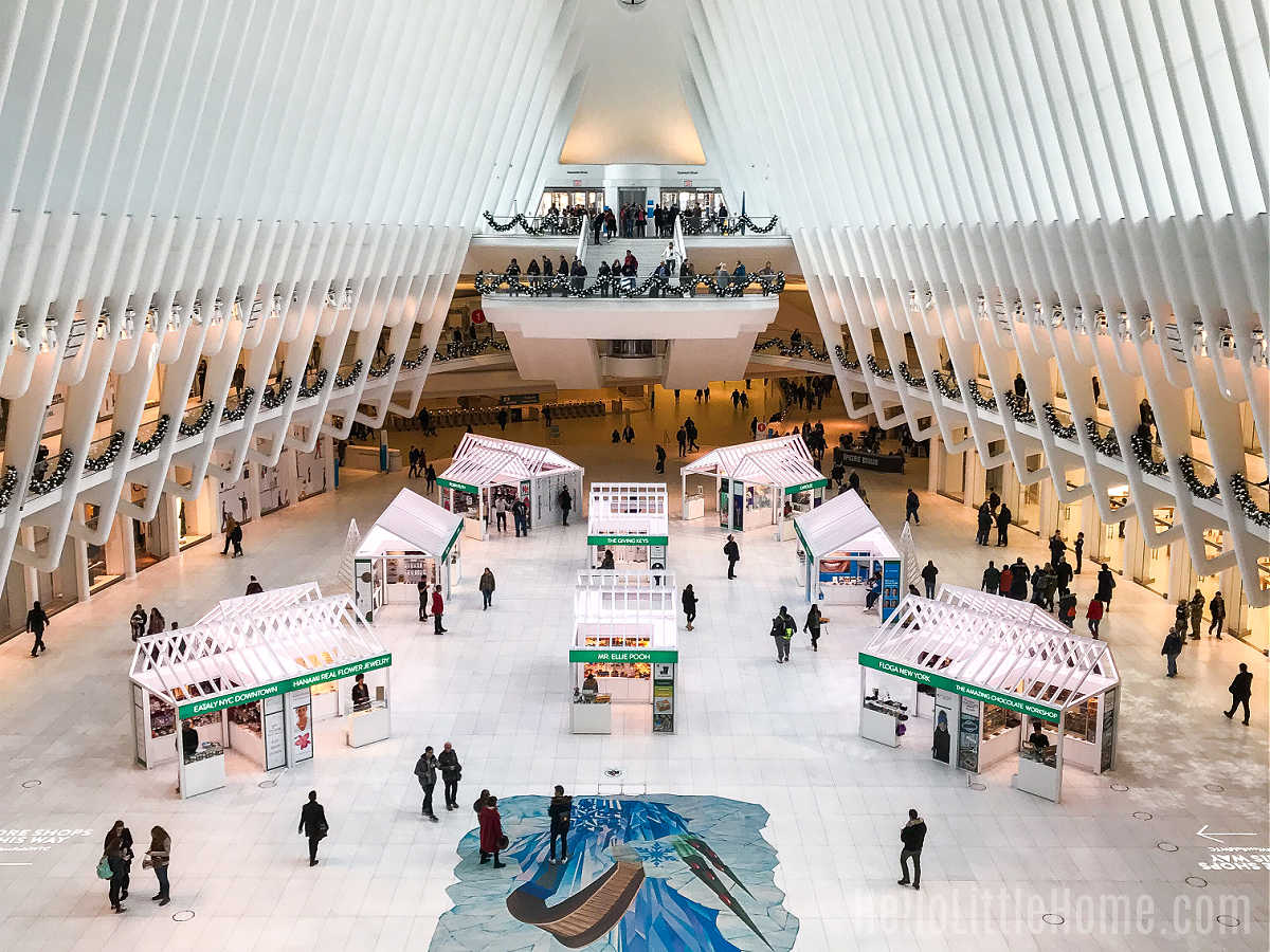 People walking among booths inside the Oculus Holiday Market.