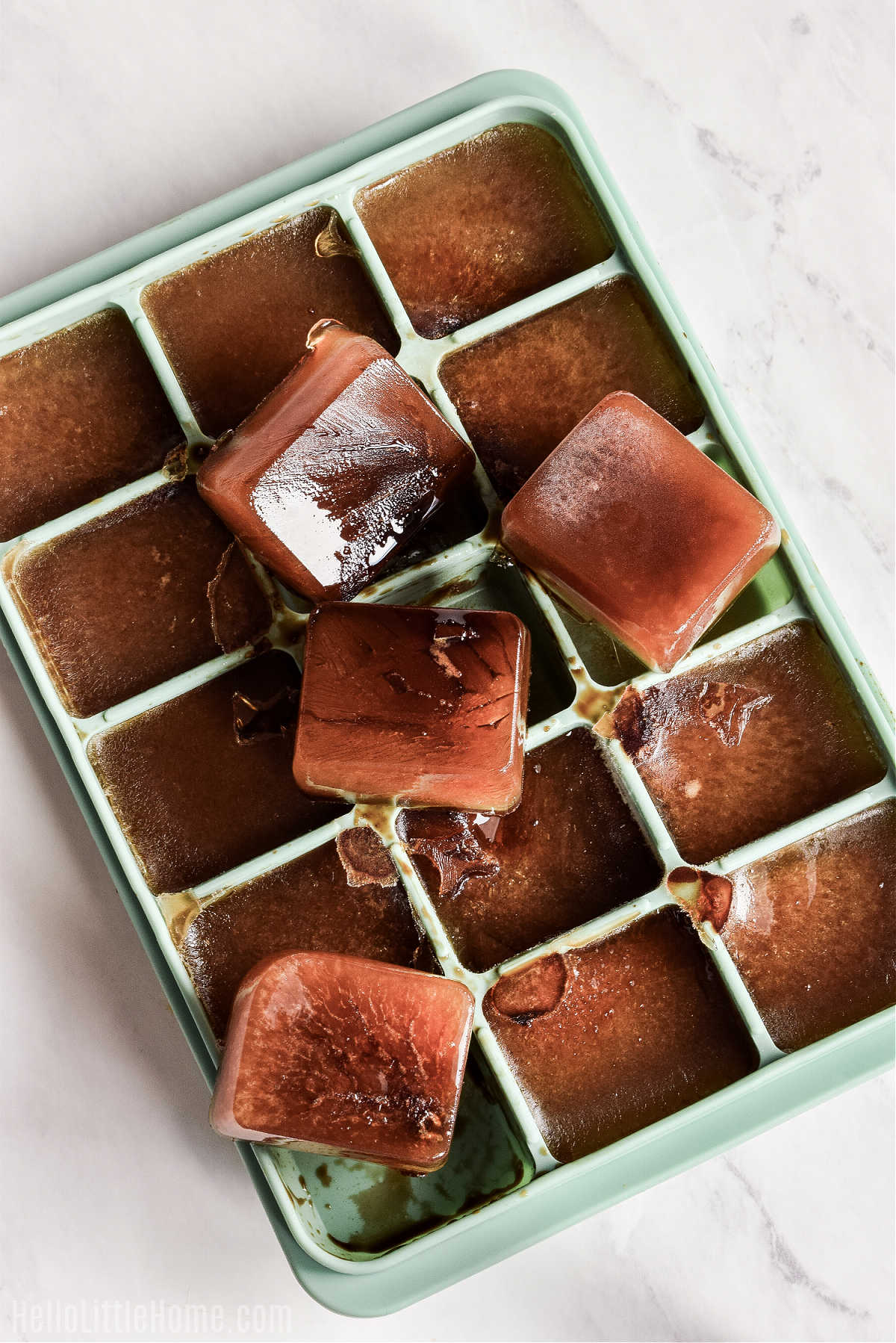 An ice cube tray filled with frozen coffee cubes.