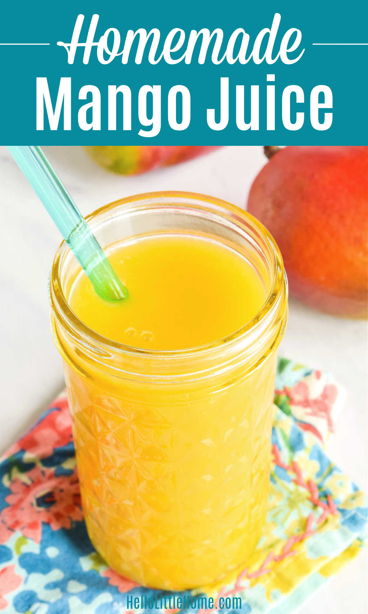 A cup of mango juice served with a straw on a colorful napkin.