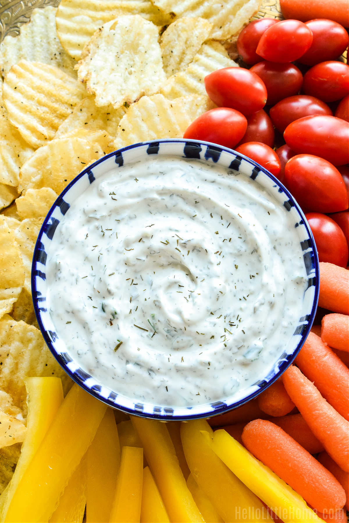 A tray topped with chips, veggies, and the finished dip.