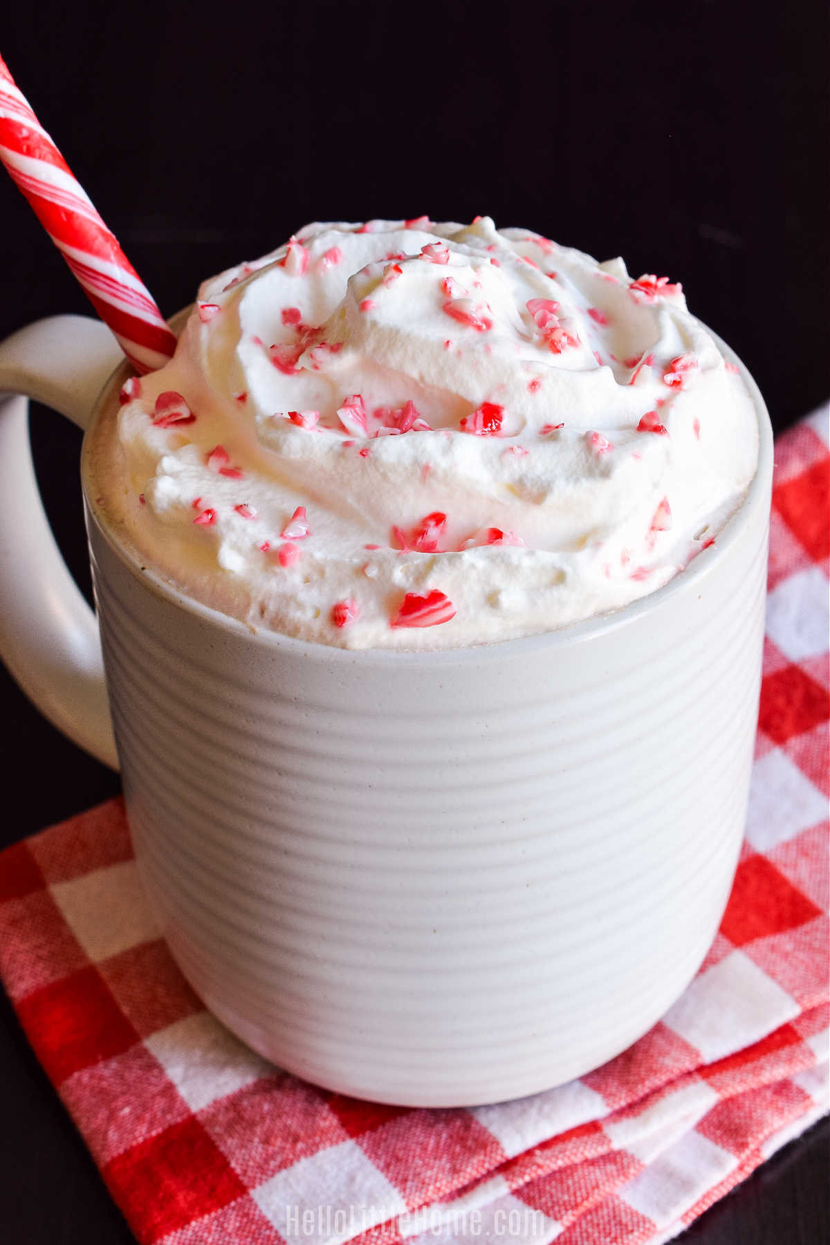 Closeup of the finished drink topped with whipped cream and crushed candy cane pieces.