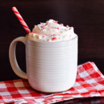 Peppermint Hot Chocolate served in a white mug on a checked napkin.