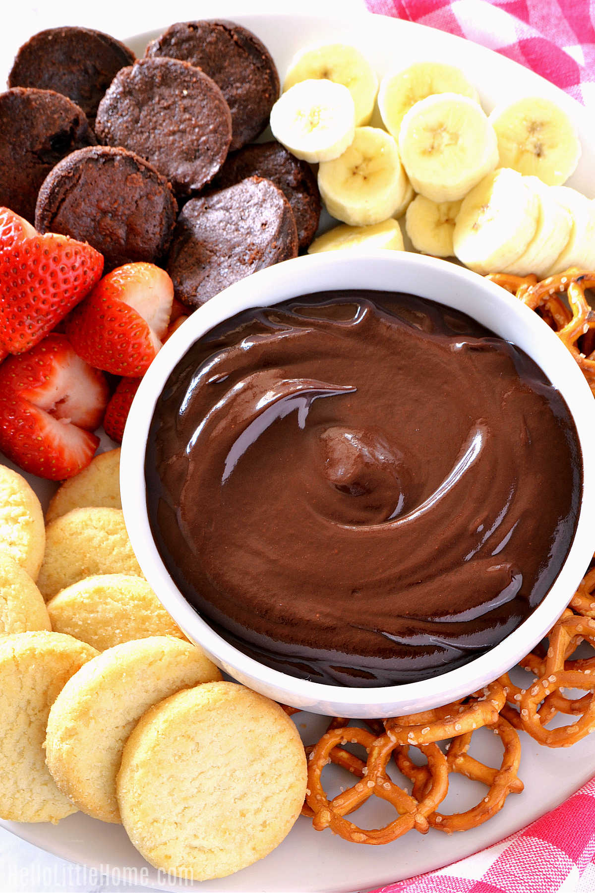 A platter topped with fondue and different foods for dipping.