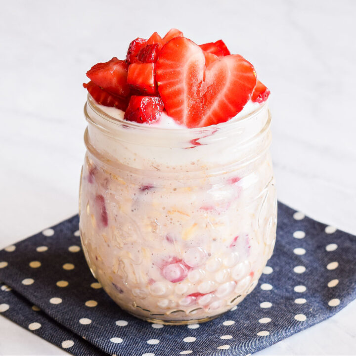Strawberry Overnight Oats served in a jar on a polka dot napkin.