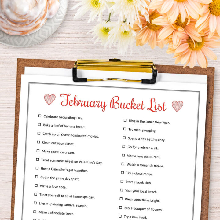 A February Bucket List on a wood clipboard.