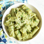 A bowl of creamy Pesto Ricotta Pasta served with a patterned napkin.