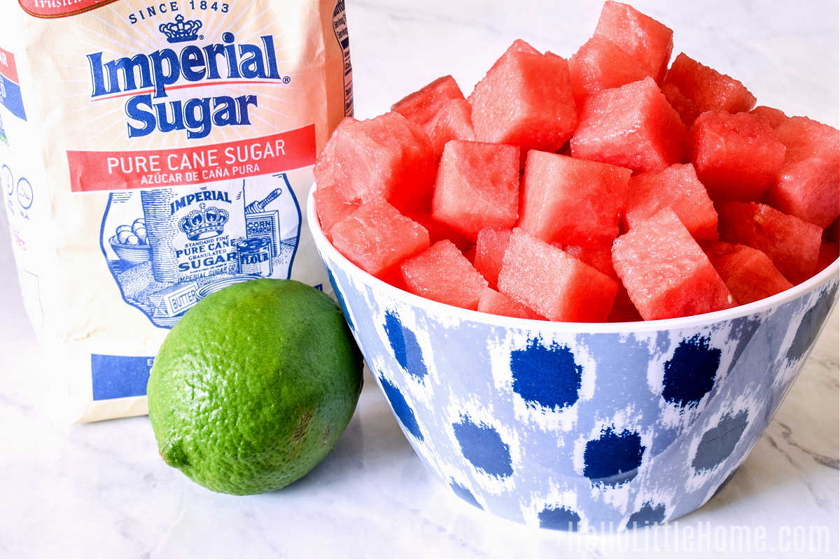 Watermelon Agua Fresca ingredients arranged together on a marble counter.