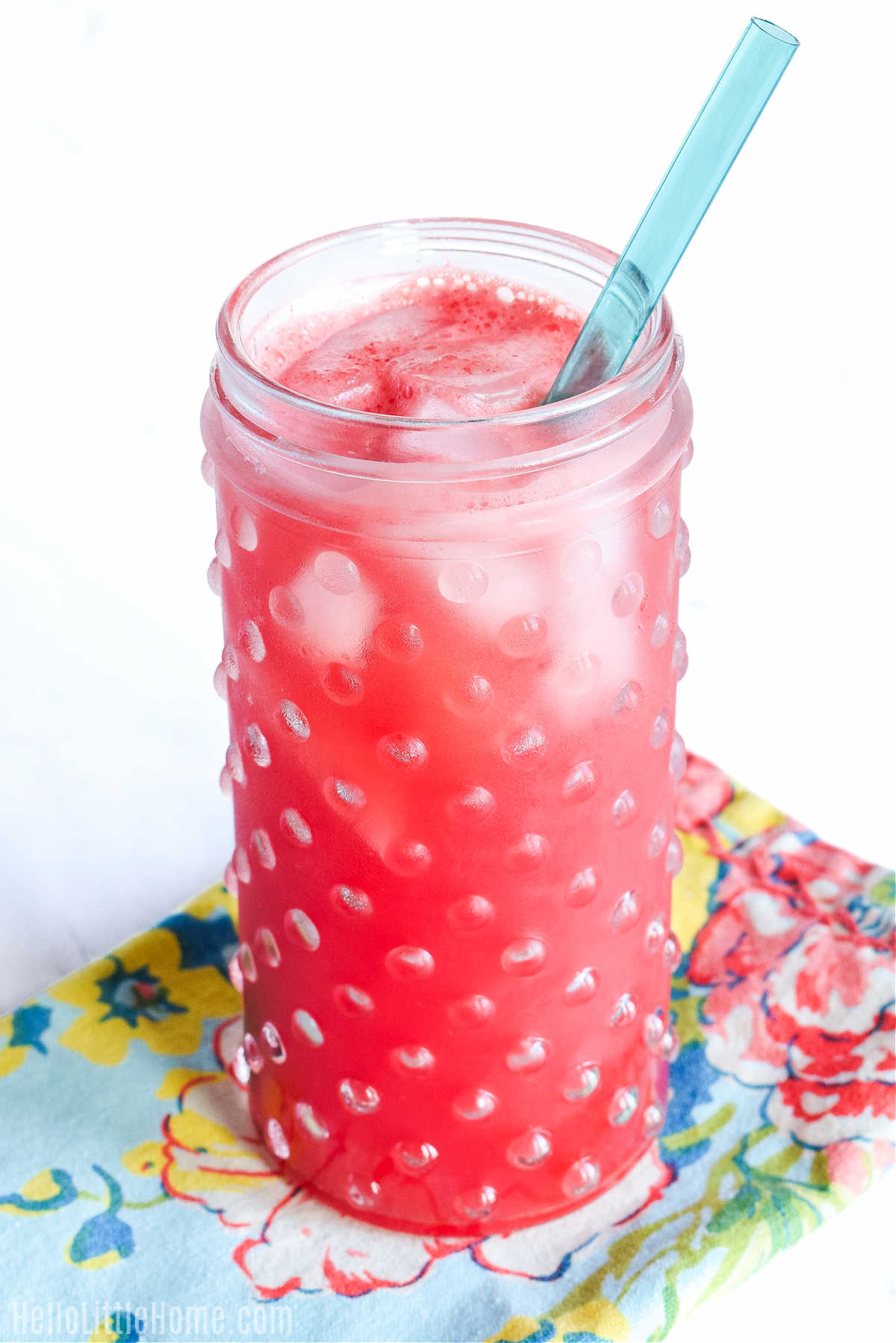 The finished Mexican fruit drink served in a tall glass with a straw.