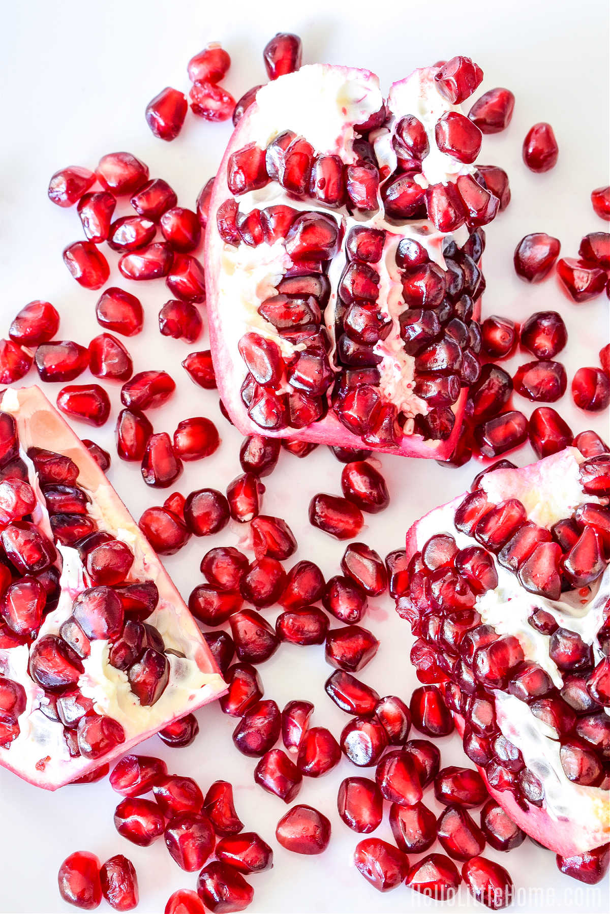 Sections of fruit and seeds on a white plate.
